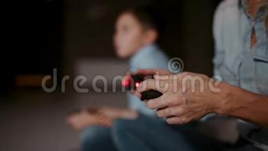 <strong>双手拿</strong>着控制器对着游戏机，在后台男孩看着水龙头，玩电子游戏